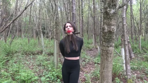 Red Ball Gag Struggles and Poses While Bound Outdoors