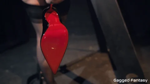 Vivian Rose bound in intricate blue and black leather harnesses