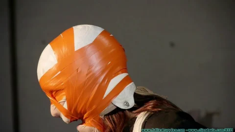 Futile Struggles – Orange and White Duct Tape Bondage