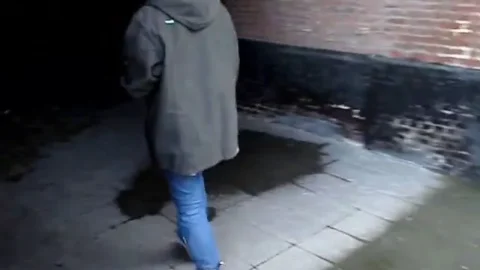 Brunette Pausing by Doorways in Old Stable Site